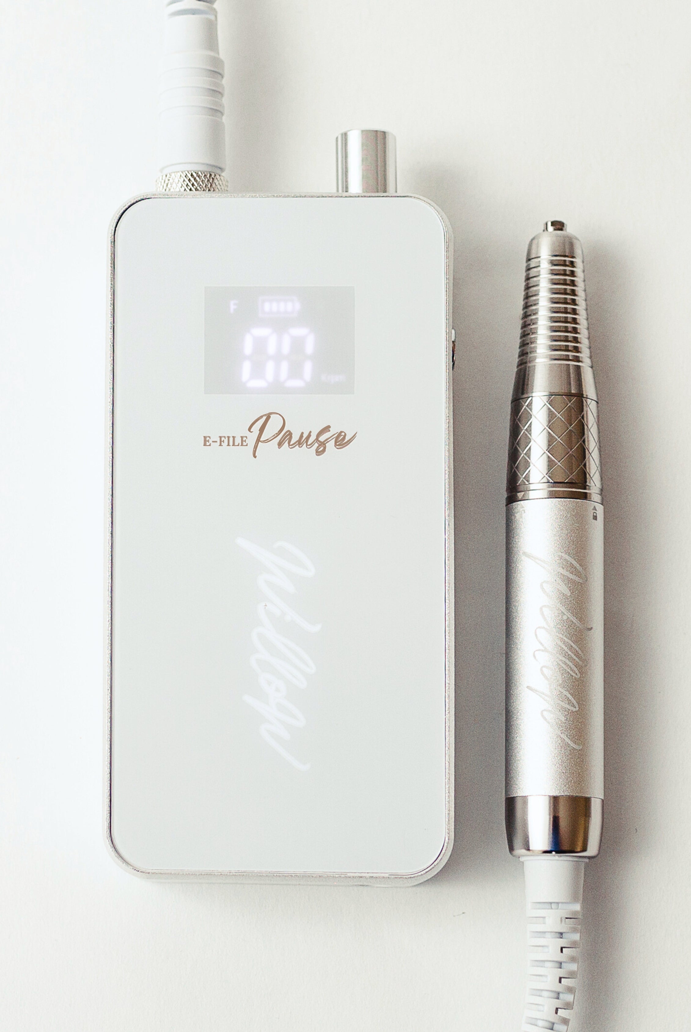 e-file pause flat-lay with handpiece