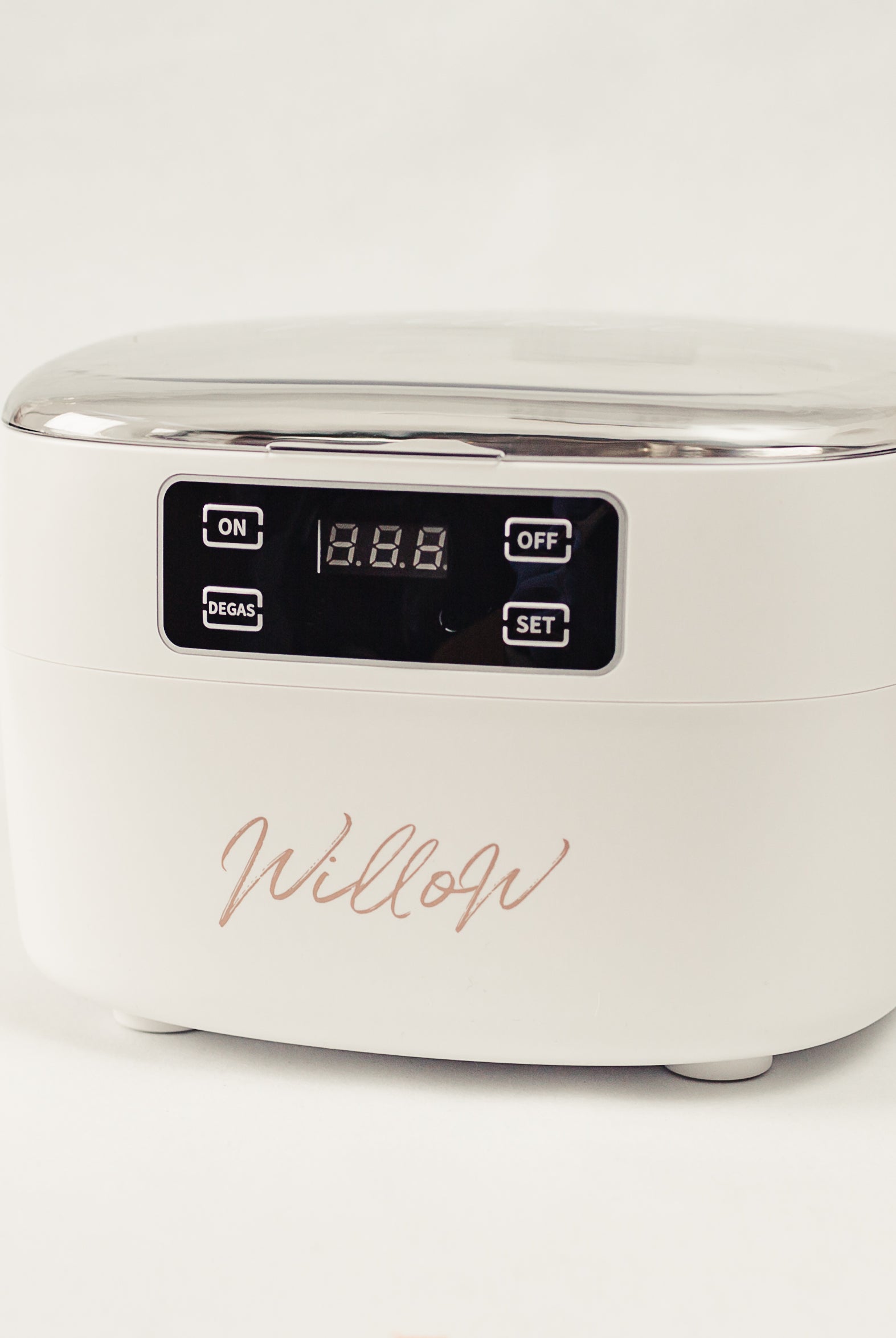 white ultrasonic cleanser with nude branding