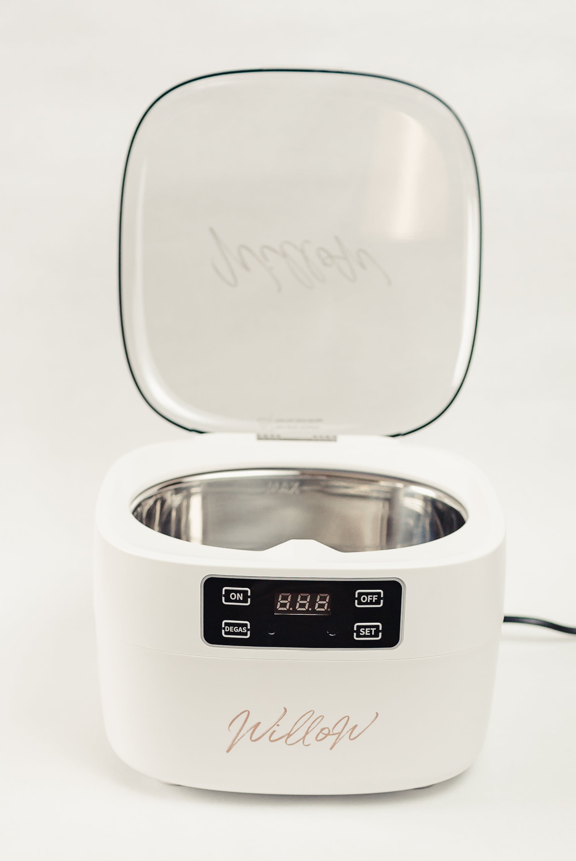 white ultrasonic cleaner with lid open showing digital display and nude Willow branding