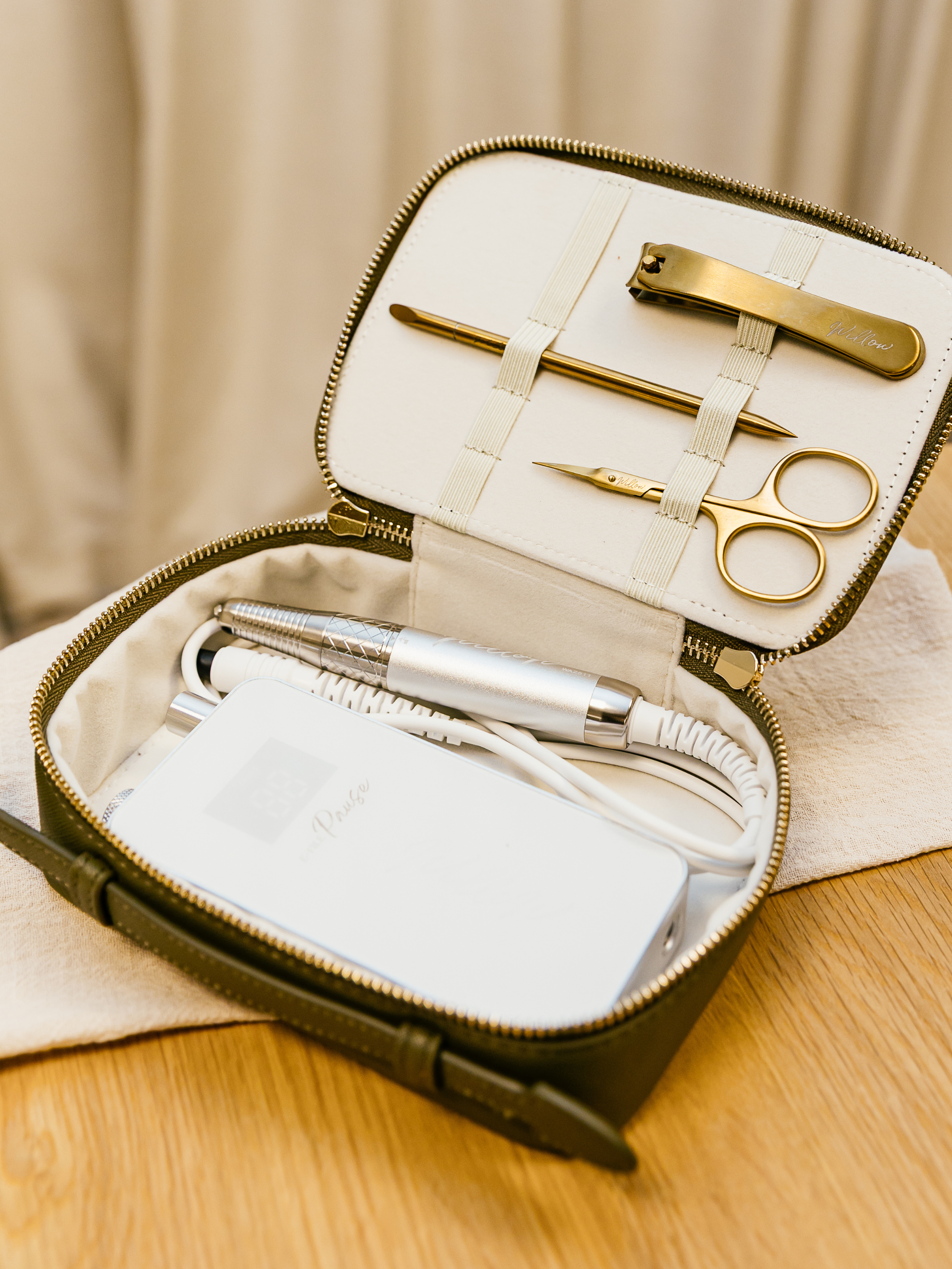 Khaki travel case showing e-file and nail tool storage solutions