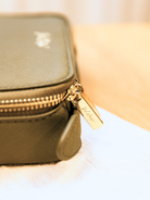 khaki travel case with gold embossed zip detail 