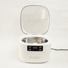 white ultrasonic cleaner with lid open showing digital display and nude Willow branding 