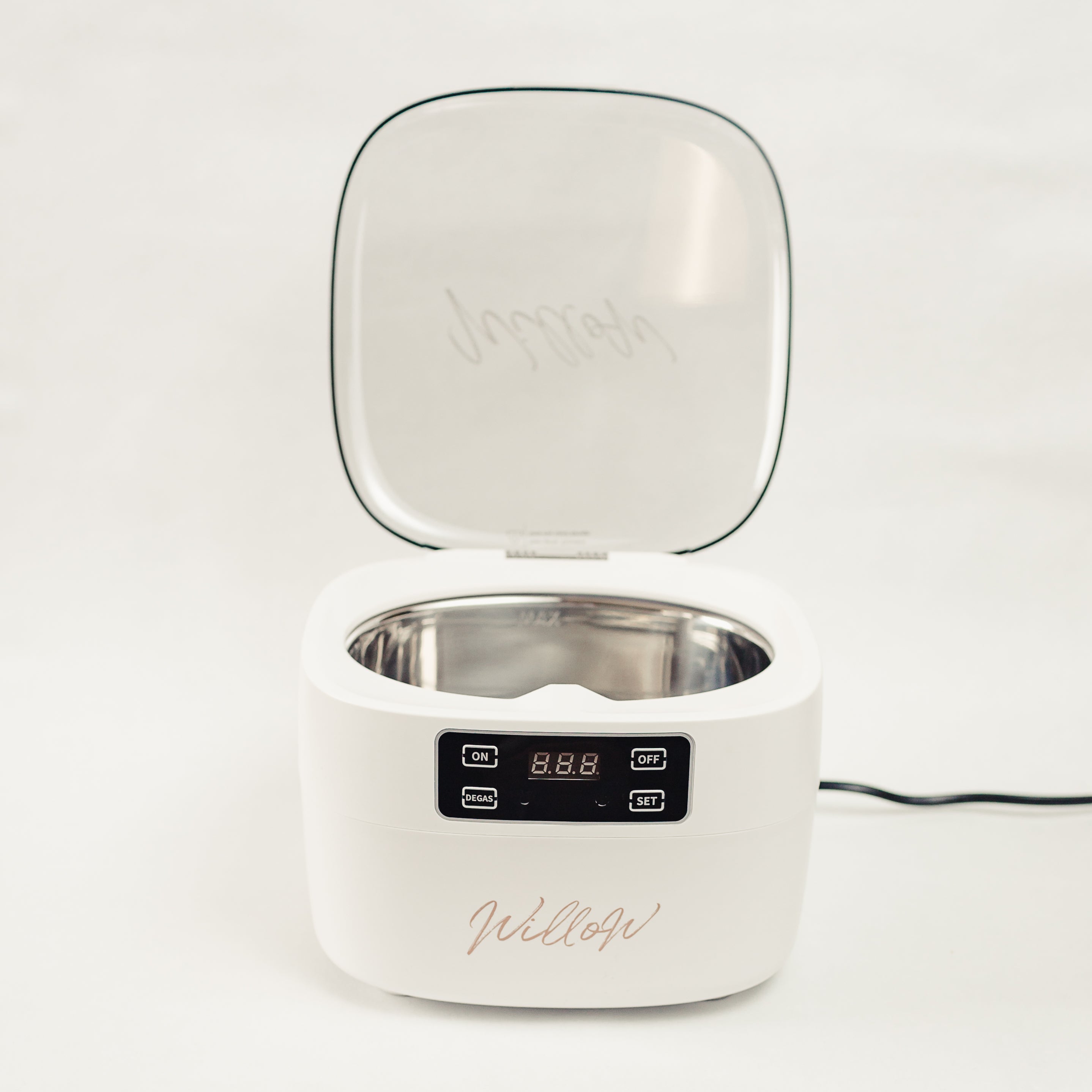 white ultrasonic cleaner with lid open showing digital display and nude Willow branding 