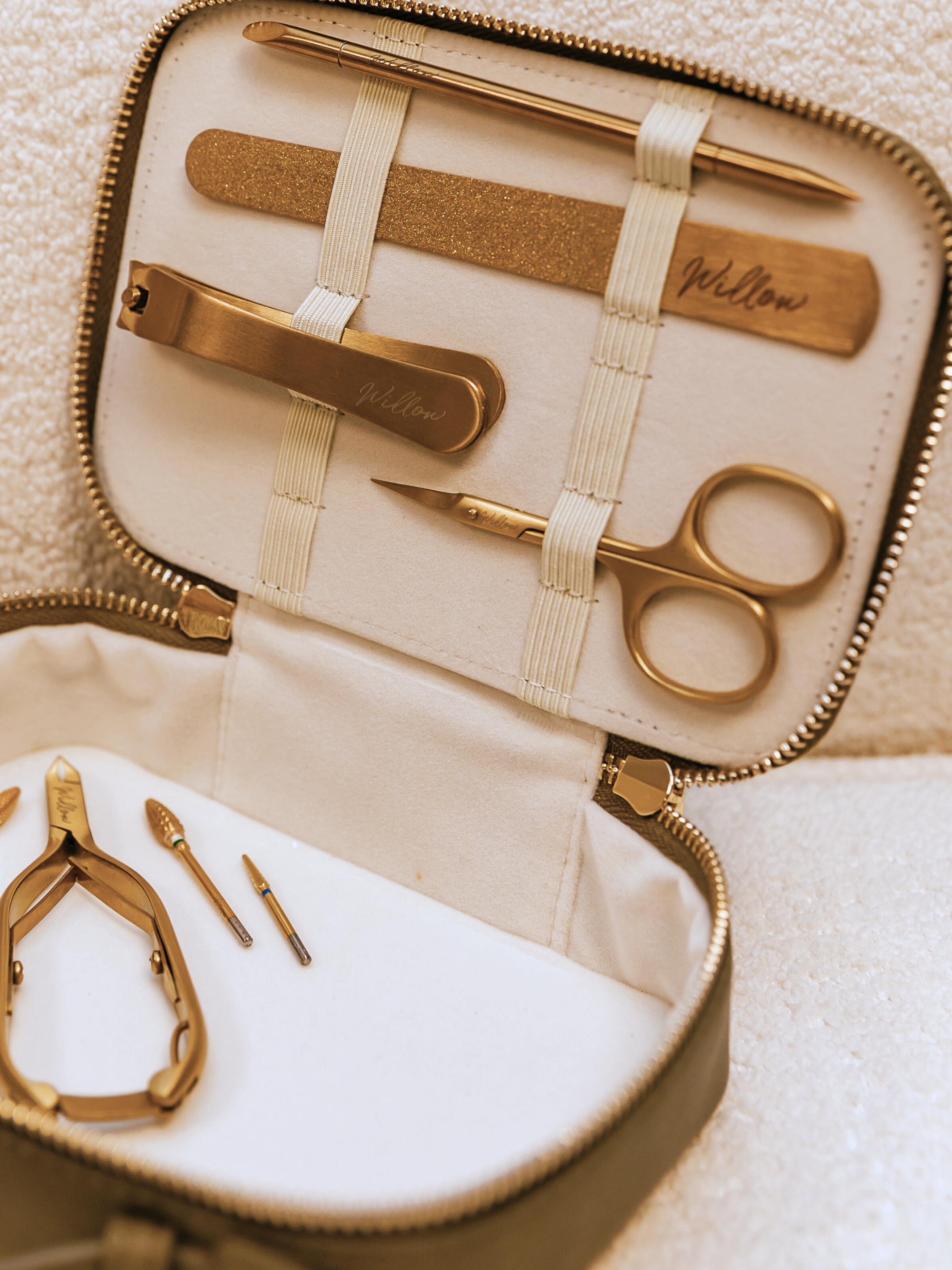 gold manicure tools on cream travel case interior 